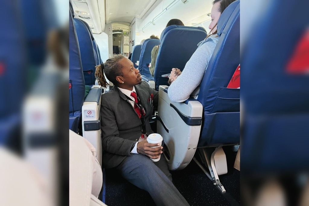 Delta flight attendant Floyd Dean-Shannon sitting in the aisle